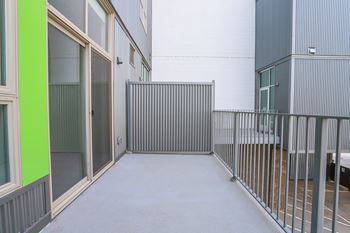 A corridor with a metal railing on the right side. at RiDE at RiNo Apartments, Denver, CO